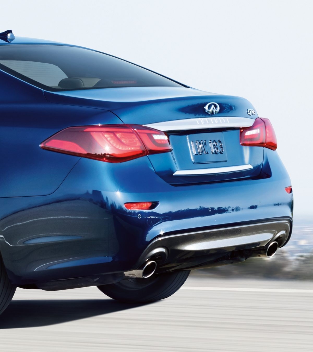 Exterior Rear Profile View Of The 2019 INFINITI Q70 Luxury Sedan&#39;s Exhaust And Tail Lights Shown In Hermosa Blue
