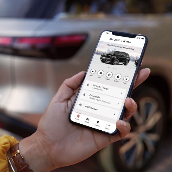 Hand holding phone with MyINFINITI Application shown on screen
