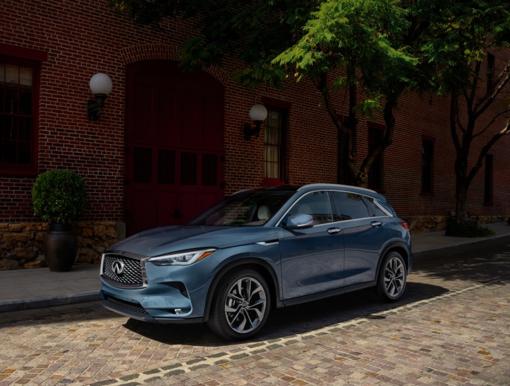 Driver-side profile view of a gray 2023 INFINITI QX50 Crossover SUV