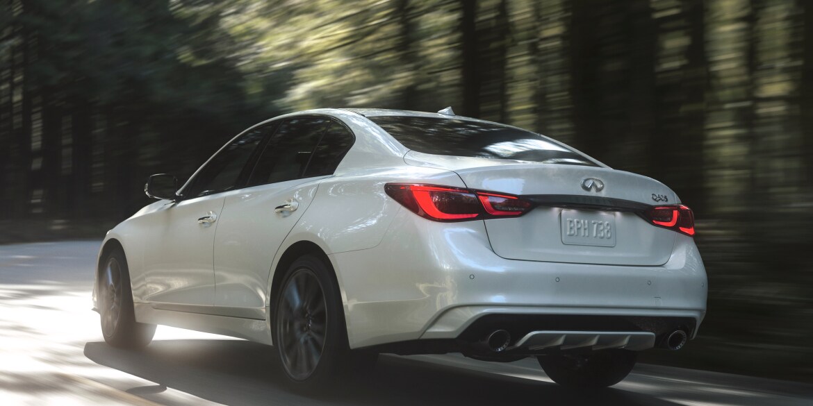 Rear profile view of 2023 INFINITI Q50 highlighting rear lights and performance-inspired exterior design