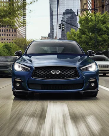 Front profile view of 2024 INFINITI Q50 exterior highlighting grille and hood design