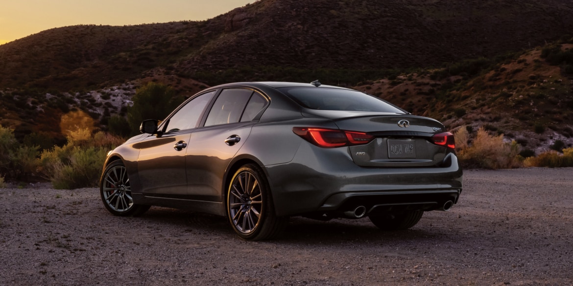 Rear profile of a 2024 INFINITI Q50 highlighting rear lights and performance-inspired exterior design