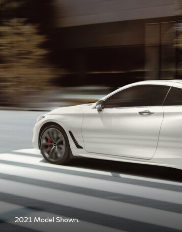 Driver side profile view of a white 2022 INFINITI Q60 exterior