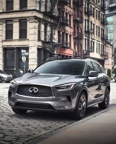 Front profile of 2023 INFINITI QX50 Crossover SUV parked on street