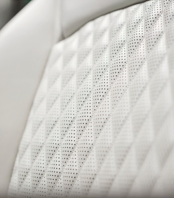 Close up view of 2023 INFINITI QX50 seat highlighting quilted leather accents