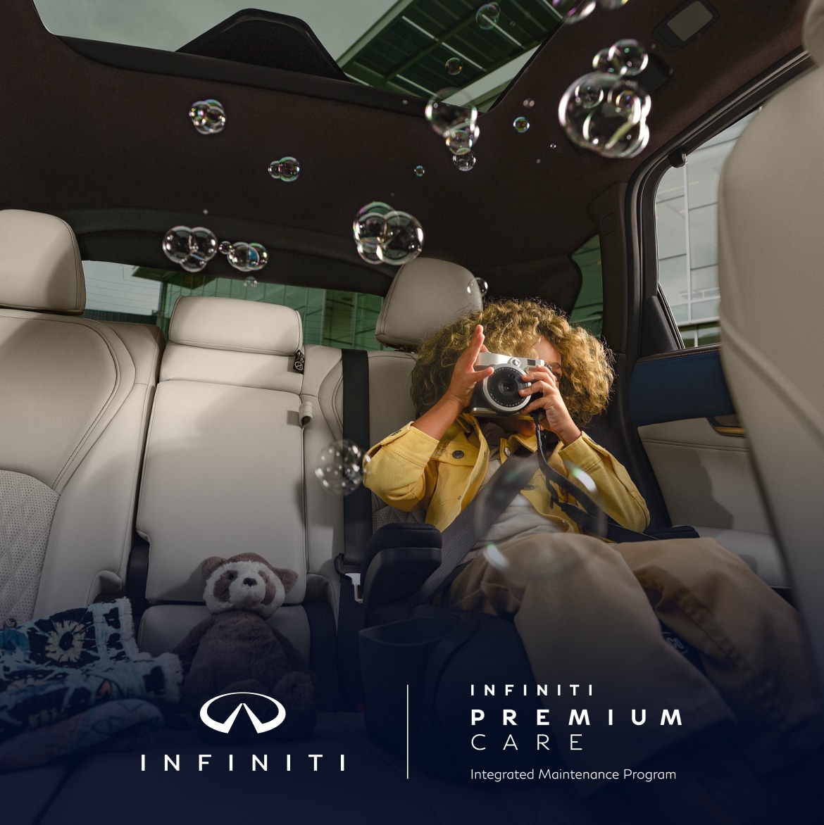 INFINITI QX50 interior with child taking photo of bubbles