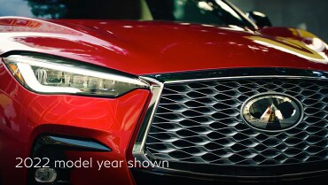 Front profile view of 2023 INFINITI QX55 grille and LED headlights highlighting exterior design