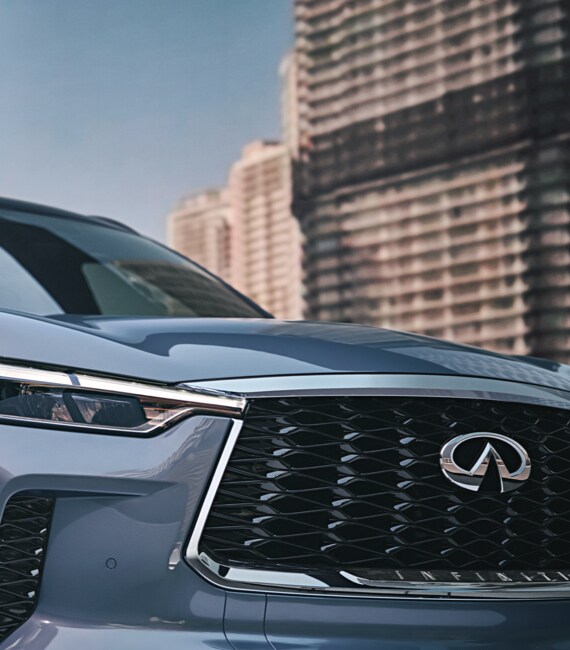 Close up view of 2023 INFINITI QX60 grille and LED headlight