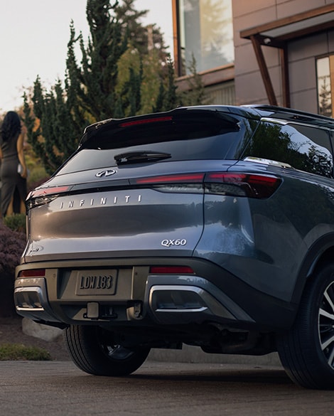 Rear exterior view of 2024 INFINITI QX60 highlighting Intelligent AWD capability