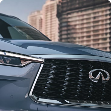 Close up view of 2024 INFINITI QX60 grille and LED headlight
