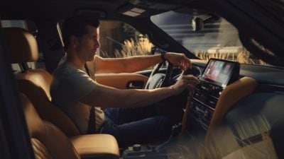 Interior view of man interacting with his INFINITI infotainment screen