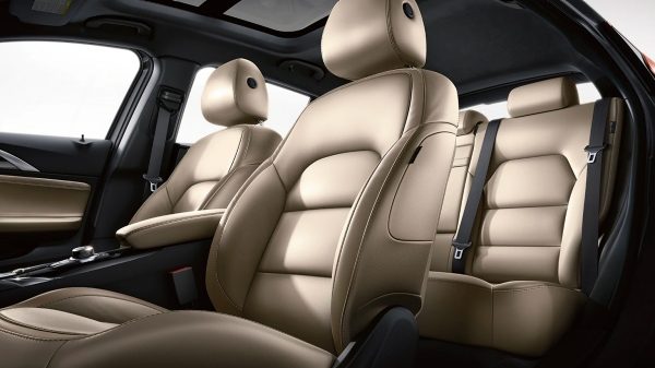 Driver-Side View Of The 2019 INFINITI QX30 Interior Wheat Leather Front And Rear Seats