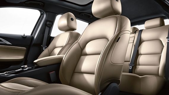 Driver-Side View Of The 2019 INFINITI QX30 Interior Wheat Leather Front And Rear Seats